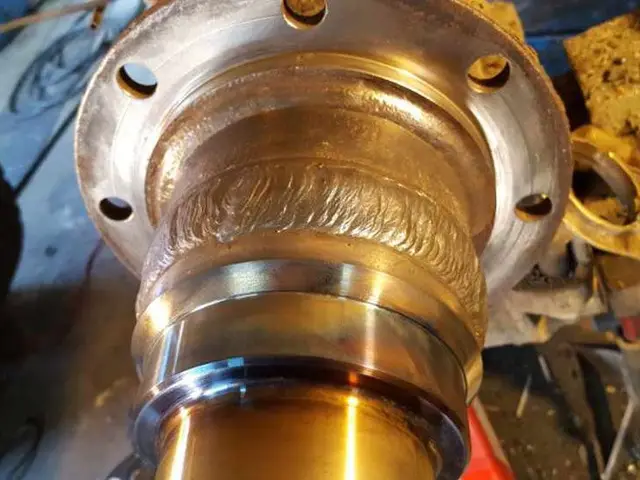 A close up of a metal object sitting on top of a wooden table.