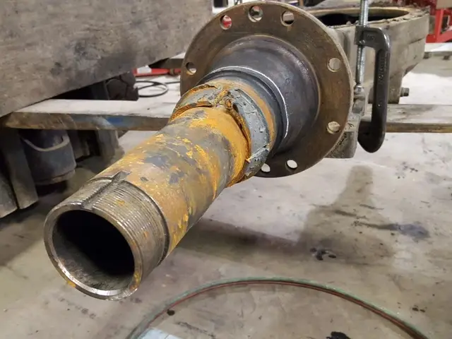 A close up of a metal pipe in a garage.