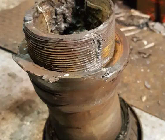 A close up of a piece of metal sitting on top of a table.