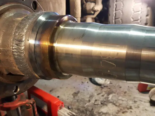 A close up of a metal pipe sitting on top of a table.